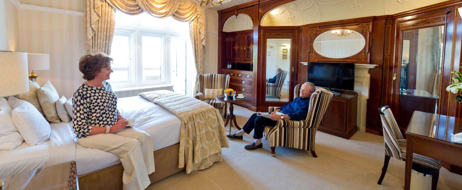 Victoria Hotel Couple Relaxing in Room with Cup of Tea