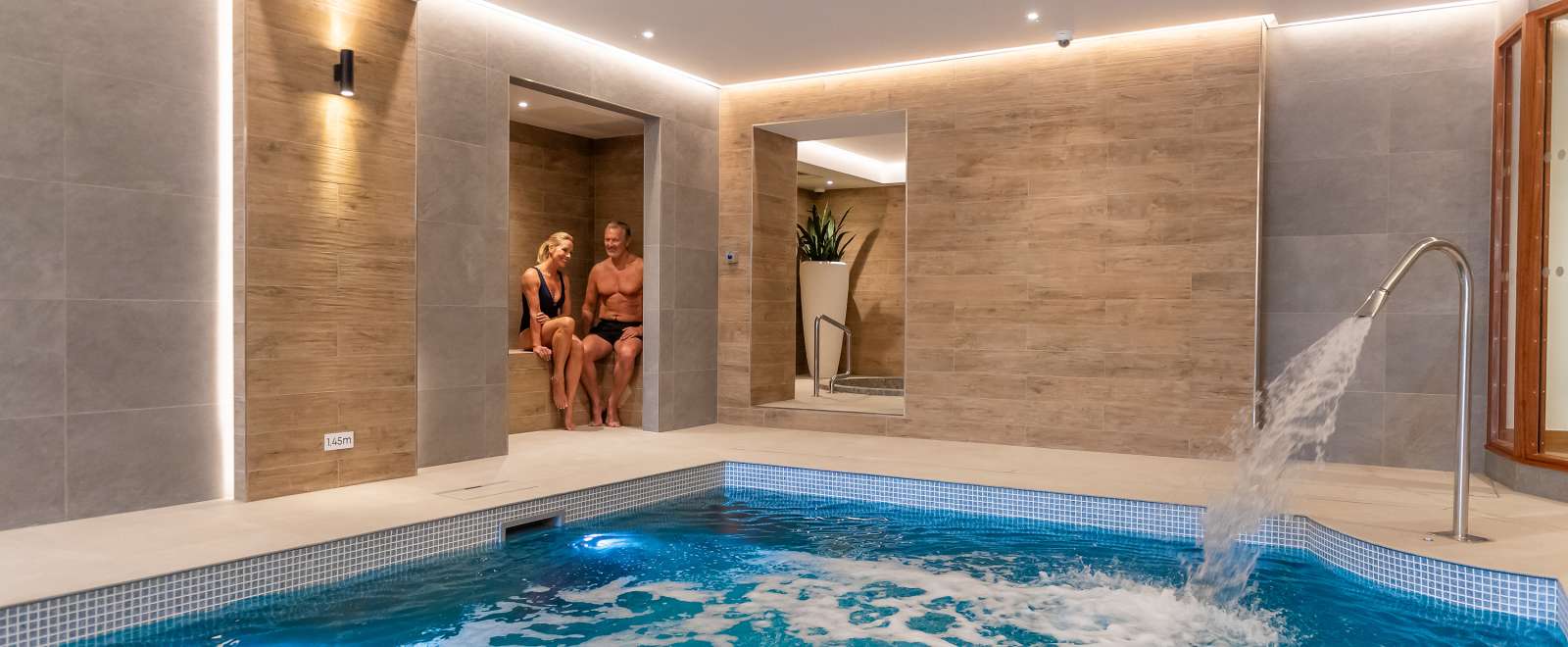 couple in seating area by pool