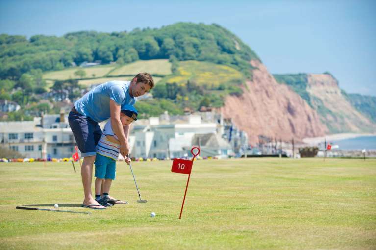 Victoria Hotel Father and Son Enjoying a Game on the Putting Green