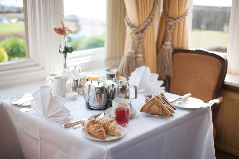 Victoria Hotel Restaurant Dining Table Laid for Breakfast with Pastries Toast and Coffee