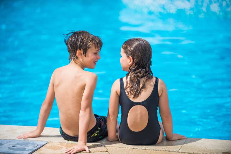 Victoria Hotel Children Sitting on Edge of Outdoor Pool