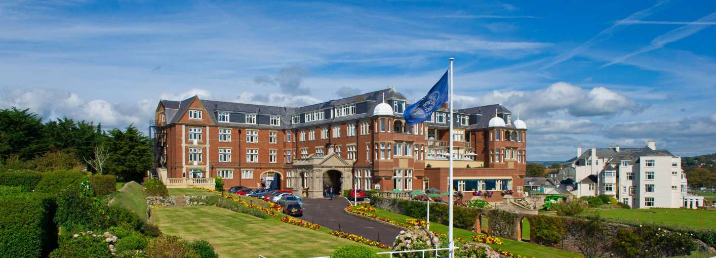 Victoria Hotel External View with Flag and Gardens