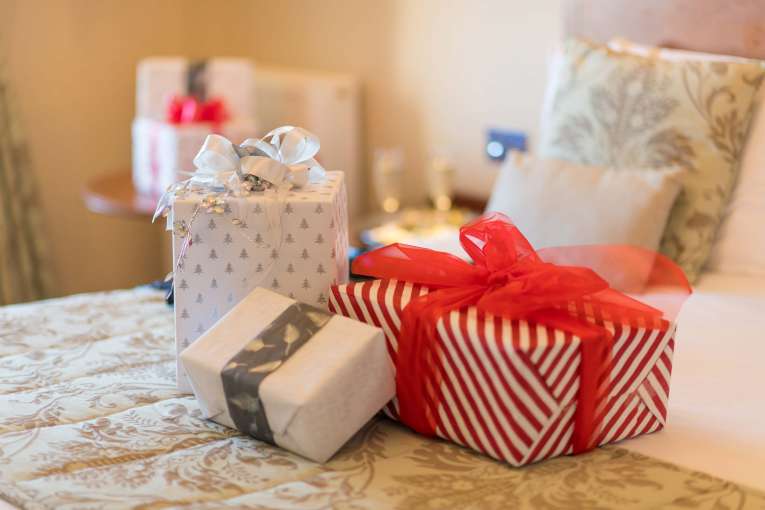 Victoria Hotel Christmas Presents on Bed in Room