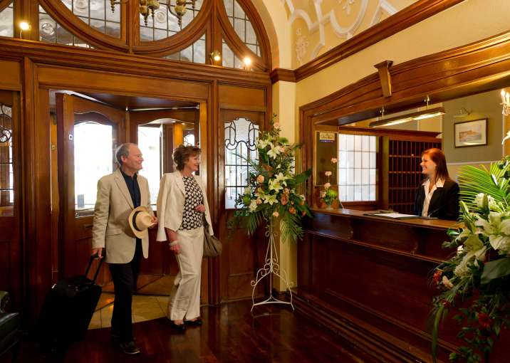 Victoria Hotel Arriving Couple Greeted at Hotel Reception in Foyer