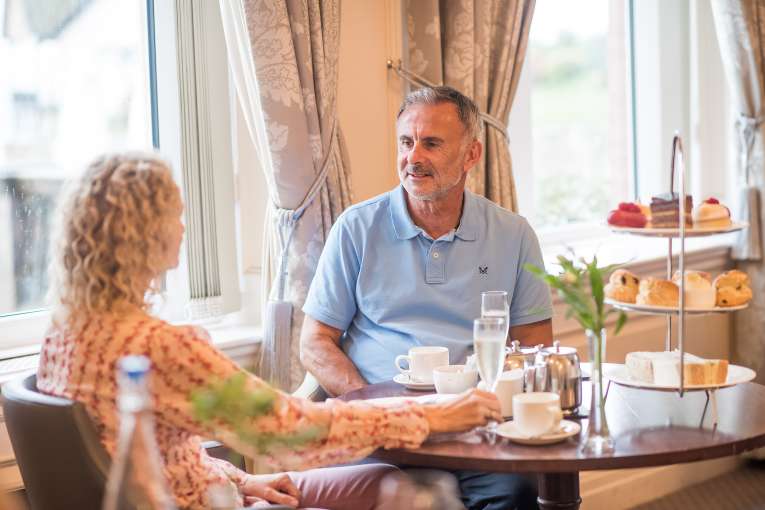 Couple Enjoying Afternoon Tea at White Room