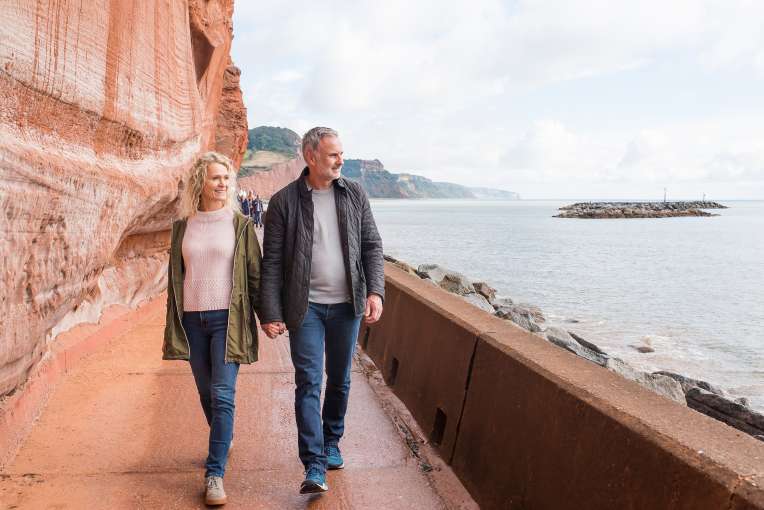 Couple Walking Along Jurassic Coast