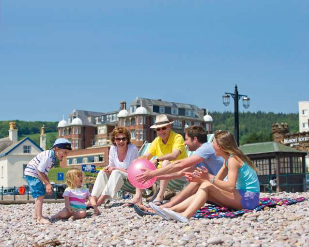 Family at Sidmouth Beach by Victoria Hotel