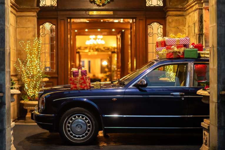 Rolls Royce at hotel entrance with Gifts on top 