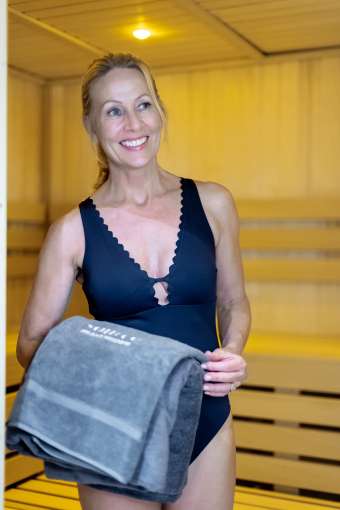 Women walking out of sauna with towel