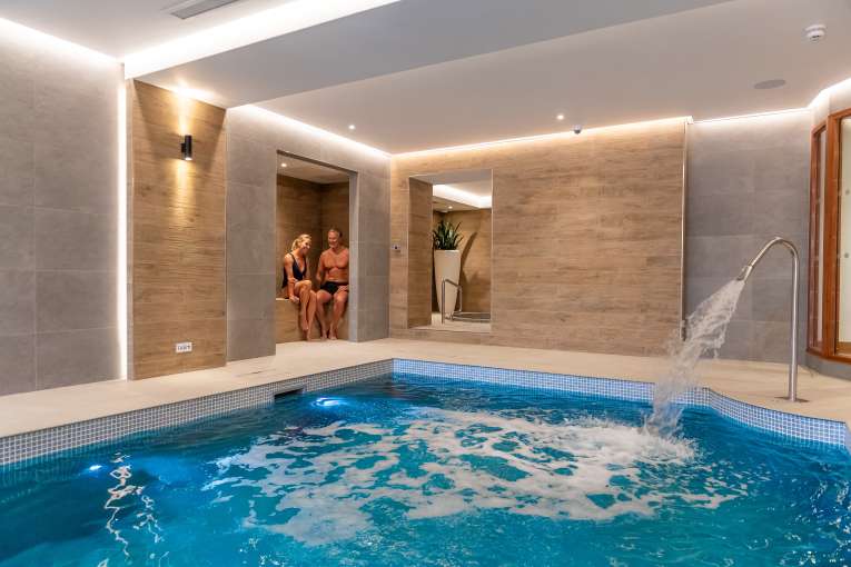 couple in seating area by pool