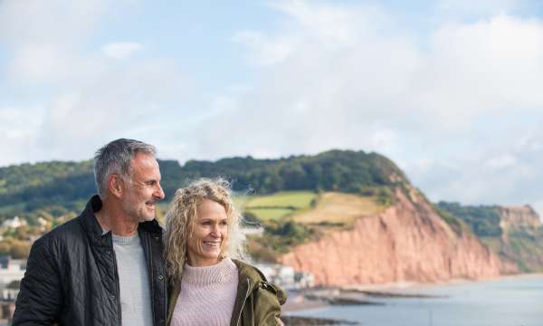 Close Up of couple Walking Along Jurassic Coast