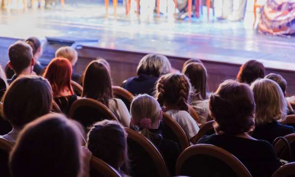 People watching theatre