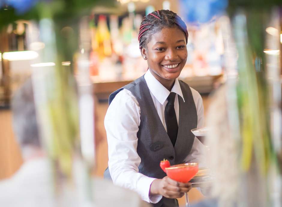 Waitress Serving Cocktail