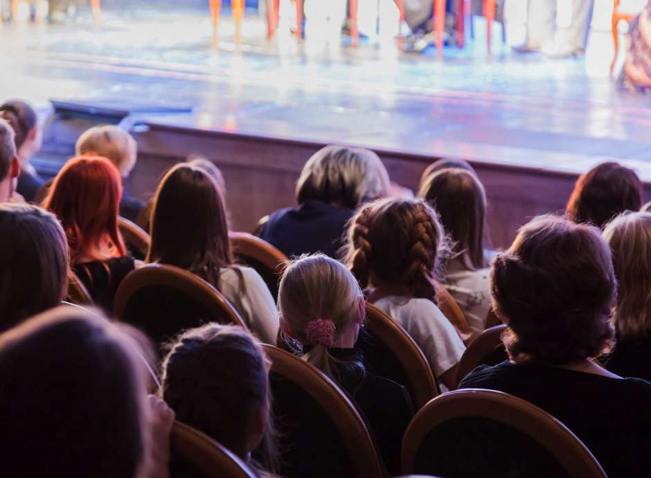 People watching theatre